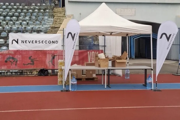 Neversecond tent and flags on the running track at the Danube 24h Run city stadium in Ruse