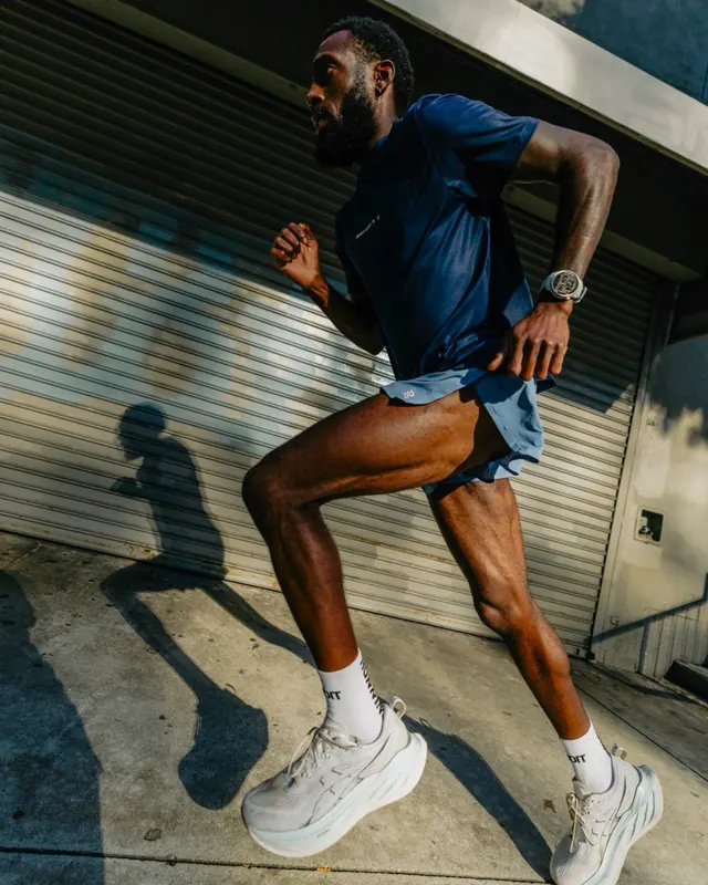 Runner wearing a COROS PACE Pro watch on a city run